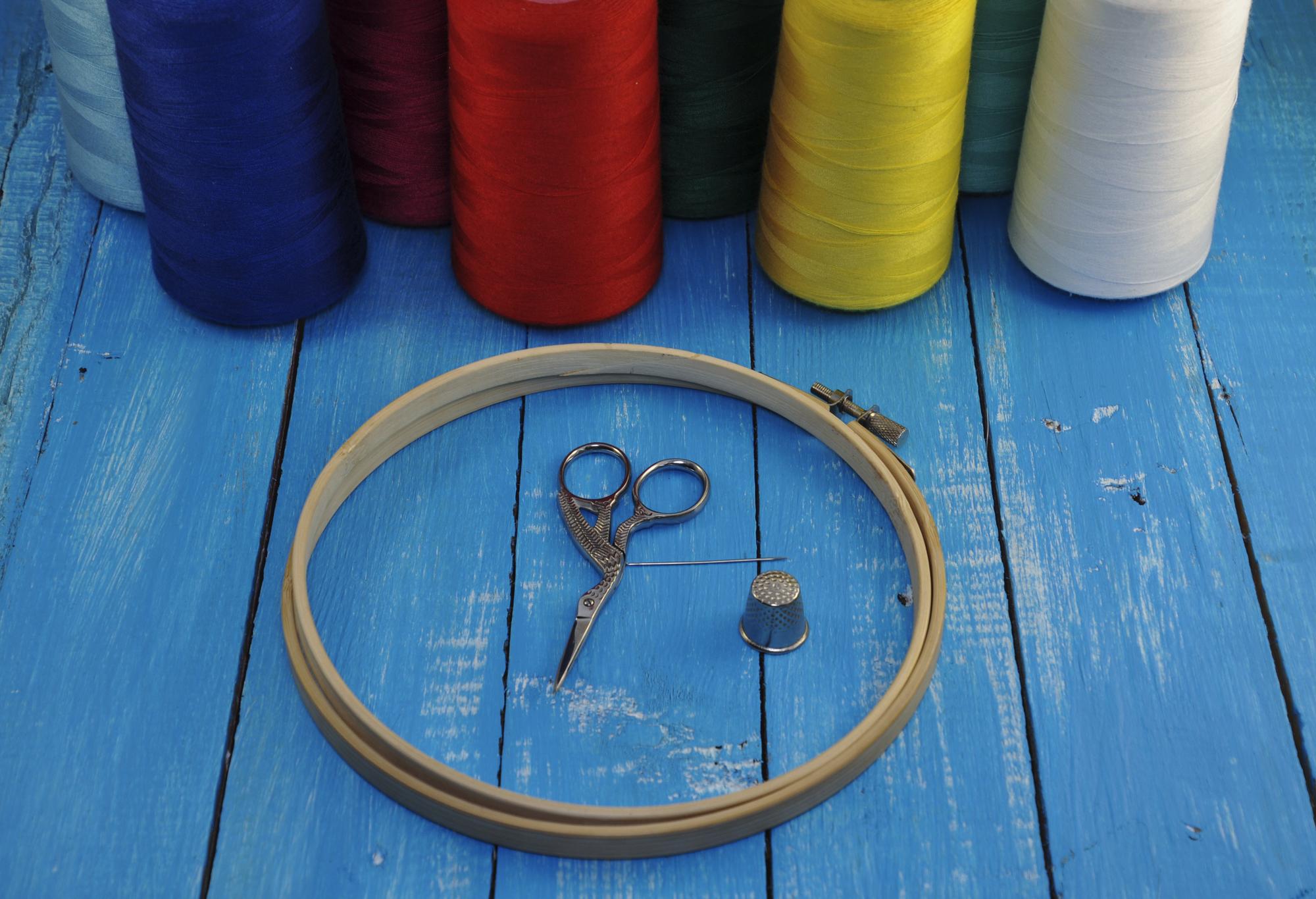 Studio workspace with embroidery machines and stacked hoops